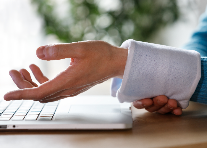 Persona aplicándose frío en la muñeca para aliviar el dolor de la tendinitis. Persona aplicándose frío en la muñeca para aliviar el dolor de la tendinitis.